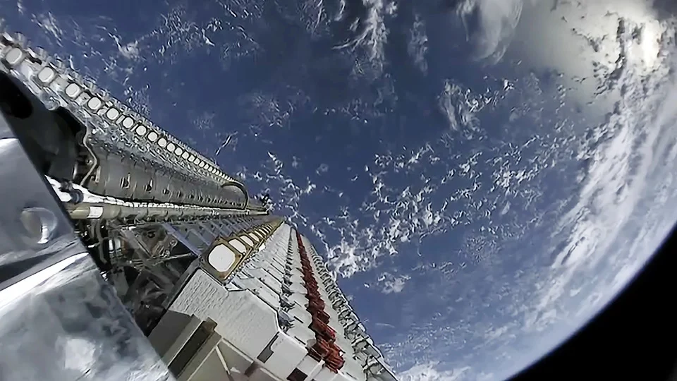 A stack of 60 Starlink satellites on a Falcon 9 rocket stage near orbit